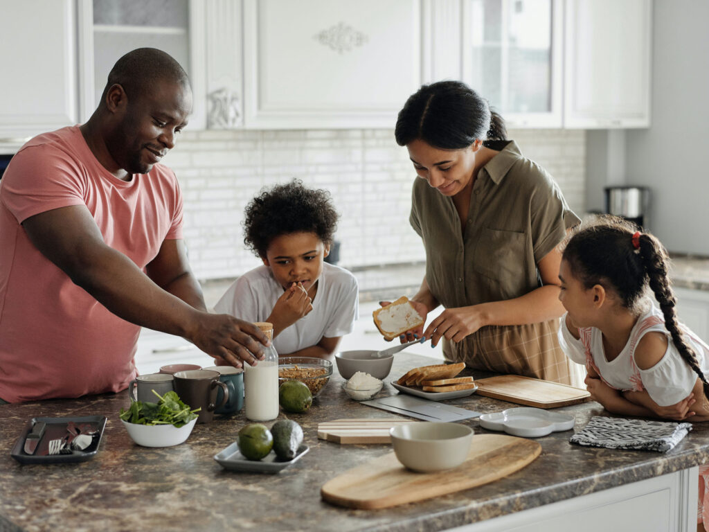 Parents enjoying breakfast with their children knowing that their little ones are safe online